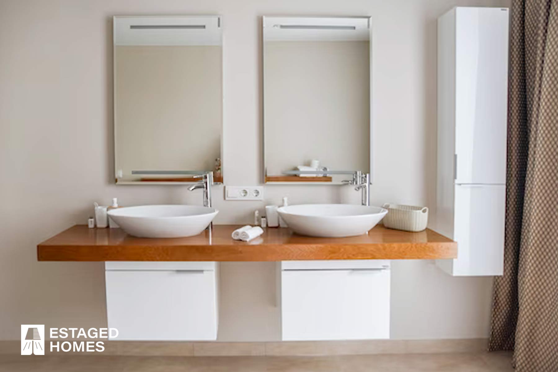 View of a modern renovated bathroom with a double vanity and ample storage